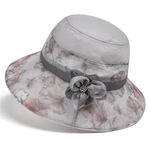 Close-up of elegant floral print brim and fabric flower detail on women sun hat
