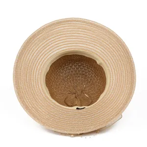 Internal view of straw sun hat showing spiral weaving and pearl decoration chain