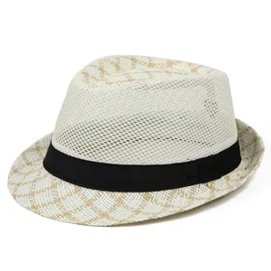 Detail of white mesh weave and beige plaid patterns on a breathable straw fedora hat