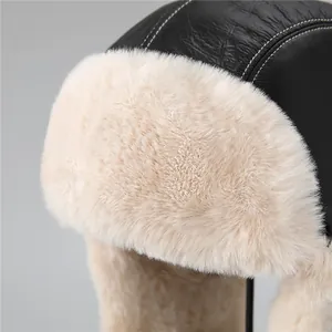 Winter bomber hat in black leather with warm beige faux fur lining and contrast stitching