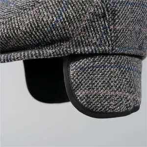 Grey herringbone winter flat cap for elderly men featuring foldable warm ear flaps