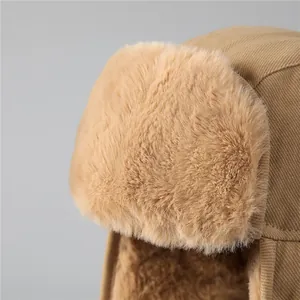 Detail of khaki windproof bomber hat with thick plush faux fur lining and quality stitching