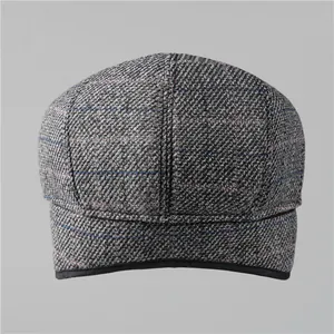 Classic grey herringbone wool flat cap for elderly men featuring warm ear flaps and winter lining