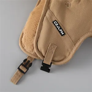 Detail of brown corduroy ushanka hat with warm faux fur lining and buckle closure