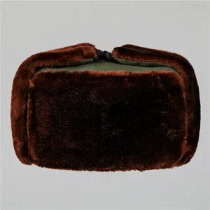 Detail of winter trapper hat with faux fur earflaps and olive green canvas crown