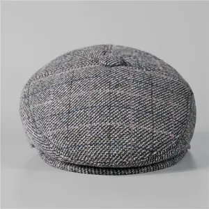 Detail of grey tweed flat cap for men with red and blue check patterns and textured fabric