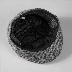 Close-up of winter men's hat featuring warm black quilted lining and gray tweed fabric