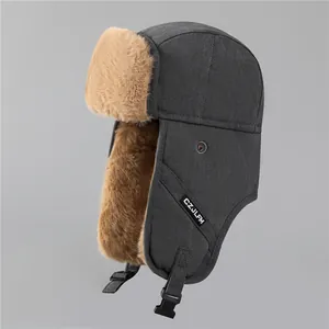Close-up of warm dark grey trapper hat with thick faux fur lining and ear flap buckle