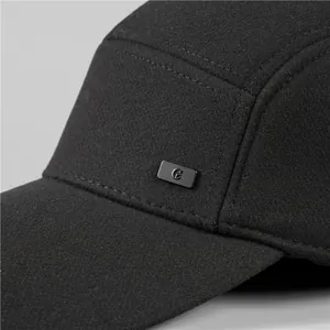 Detailed macro view of gray wool baseball cap with metallic logo and premium stitching