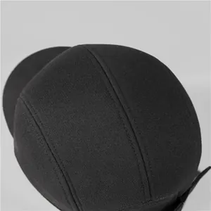 Detailed top view of a black 5-panel thermal baseball cap with refined stitching lines