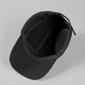 Detailed interior of a black thermal winter hat featuring foldable ear flaps and clean stitching