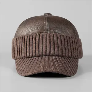 Detail of winter baseball cap with dark brown leather crown and ribbed knit brim