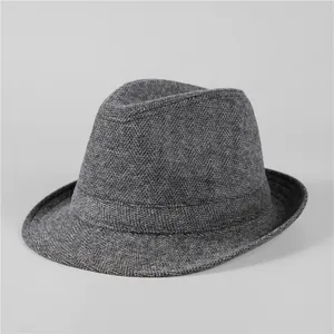 Close-up of grey wool fedora hat showing textured herringbone fabric and classic band
