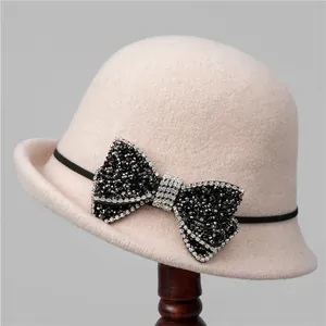 Pink wool felt cloche hat for women featuring a large sparkling rhinestone bow accent