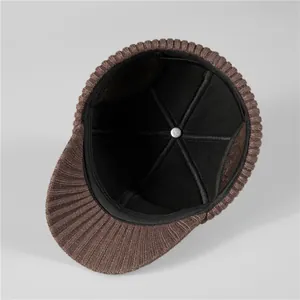 Detail view of winter hat interior showing warm black lining and reinforced stitching