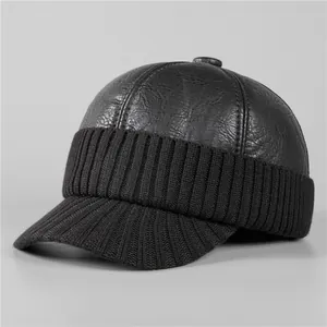 Detailed shot of black faux leather and ribbed knit stitching on winter baseball cap