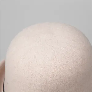 Macro detail of high-quality beige wool felt texture and craftsmanship on a cloche hat