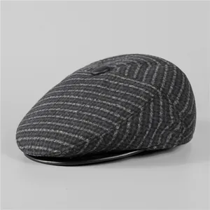 Detail view of winter flat cap with striped wool texture and black leather brim