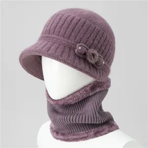 Detail of purple knitted winter hat and scarf set with thick plush lining and elegant bow