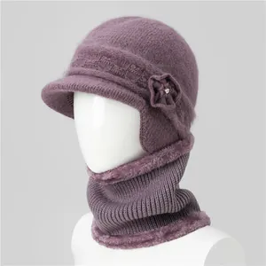 Detailed texture of purple wool blend knit winter hat and neck warmer with floral accent