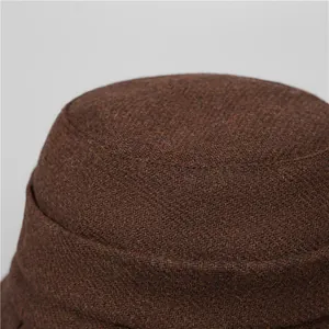 Detail of the thick brown tweed fabric and stitching on a warm winter bucket hat