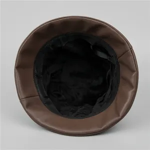 Detailed view of the brown leather bucket hat showing its warm black fleece lining