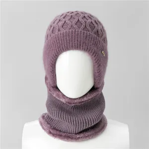 Close-up of purple knit hat with warm plush lining and stylish metal logo detail
