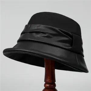 Detail shot of black elegant winter bucket hat for elderly women on a wooden stand