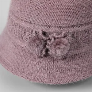 Women's knitted cloche hat in dusty purple with fleece lining and decorative pom-poms