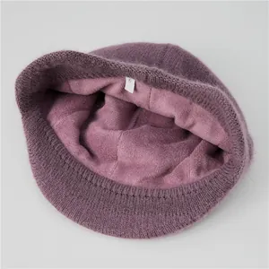 Detailed view of winter knitted hat featuring thick purple faux fur lining for warmth
