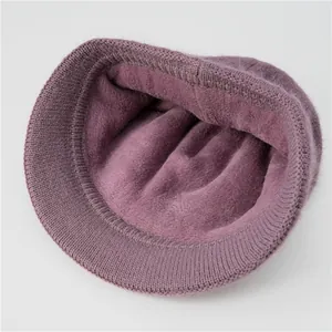 Detailed close-up of the warm plush lining and purple knitted fabric on the winter hat