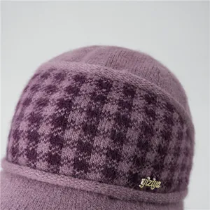 Close-up of purple winter knit hat showing thick thermal fleece texture and metal logo