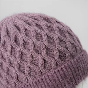 Close-up of purple knit beanie showing soft fuzzy texture and intricate cable patterns