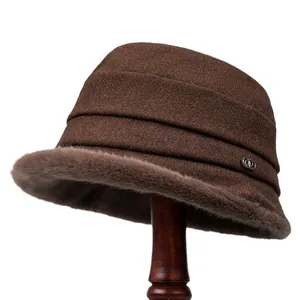 Women's warm winter bucket hat in dark brown tweed with plush faux fur trim and metal logo