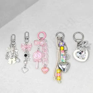 Detailed view of colorful acrylic phone charms with bowknots, beads, and heart pendants