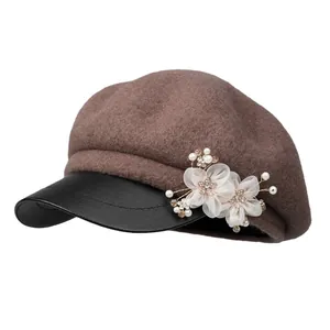 Brown wool newsboy hat for women with black leather brim and elegant flower detail