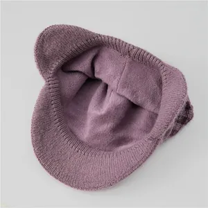 Close-up of lilac purple winter hat showing dense knit texture and warm fleece lining