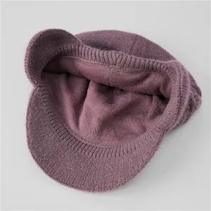 Detail view of the thick fleece lining and purple knit texture of the warm winter hat