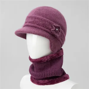 Detail of purple knitted winter hat with earflaps and scarf set for elderly women