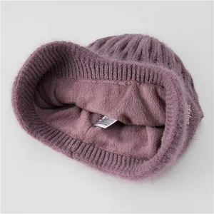Detail view of thickened purple fleece lining in warm knitted hat for elderly women