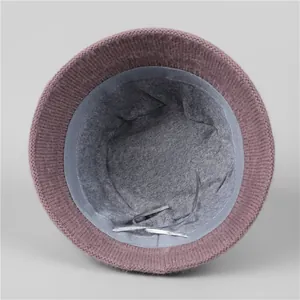 Detail of warm winter bucket hat showing pink knit fabric and soft grey fleece lining