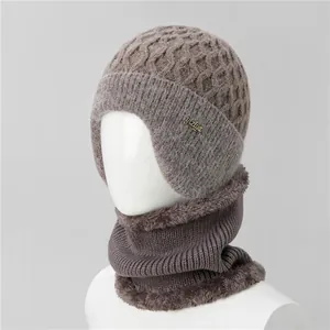 Detail of winter knit hat and neck warmer with plush lining and metal logo tag