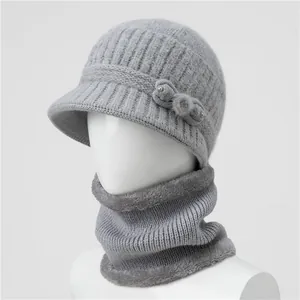 Detailed close-up of grey knitted hat with bow decoration and fleece-lined winter neck warmer