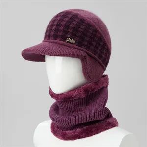 Detailed view of the purple knit hat with ear flaps and soft fleece lining for warmth