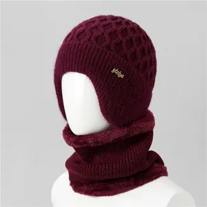 Macro view of burgundy winter knit hat and scarf set with thick faux fur fleece lining