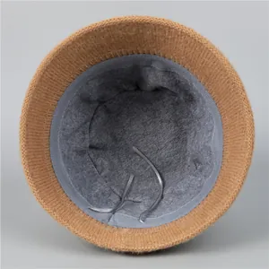 Detail view of winter knitted hat showing grey fleece lining and adjustable inner straps