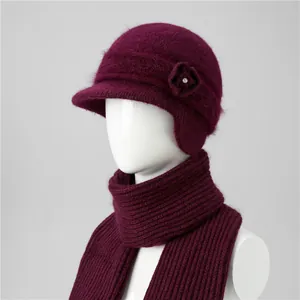 Close-up of burgundy rabbit fur blend knit hat and scarf set with floral detail