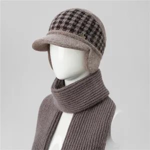 Detail of winter knit ear-flap hat with houndstooth pattern and matching ribbed scarf
