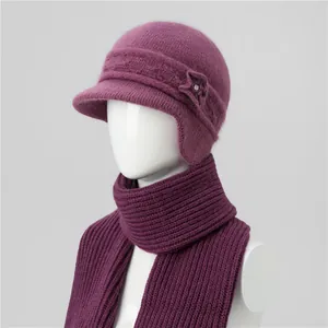 Detail of purple winter knit hat with rabbit fur texture, floral decor and matching scarf