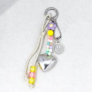 Detail of colorful acrylic phone strap featuring heart charms and purple flower beads